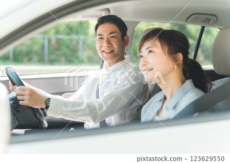 A middle-aged couple having a pleasant conversation while driving 123629550