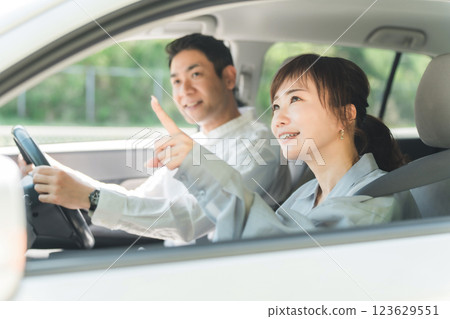 A middle-aged couple having a pleasant conversation while driving A middle-aged couple having a pleasant conversation while driving 123629551