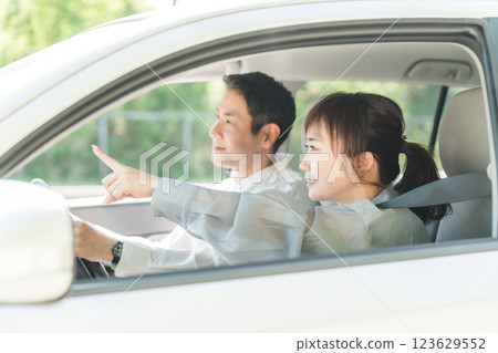 A middle-aged couple having a pleasant conversation while driving A middle-aged couple having a pleasant conversation while driving 123629552