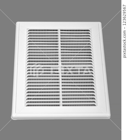 White ventilation grate on a gray background. Rectangular shape, plastic material. 123629567
