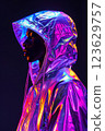 A person is wearing a shiny, metallic jacket with a hood. Cyberpunk concept 123629757