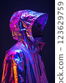 A person is wearing a shiny, metallic jacket with a hood. Cyberpunk concept 123629759