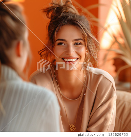 A woman with a smile on her face is sitting next to another woman. Therapy concept A woman with a smile on her face is sitting next to another woman. Therapy concept 123629763
