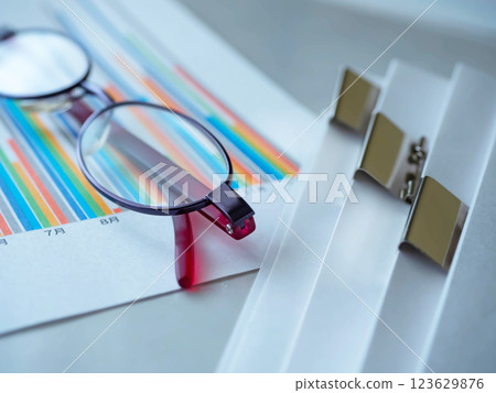 Graphs, glasses and documents on the table 123629876