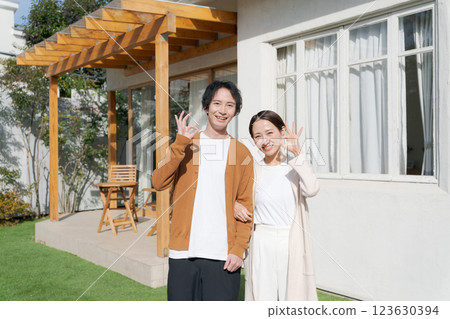 A smiling couple in the garden of their home 123630394