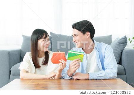 A couple holding a wallet and a bankbook 123630552