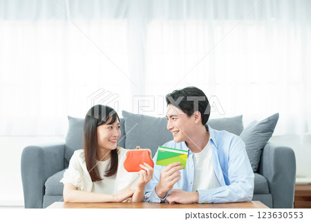 A couple holding a wallet and a bankbook 123630553
