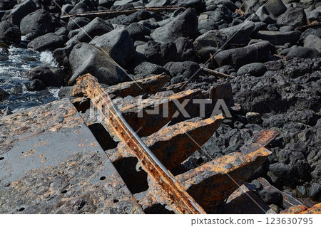 Rusty metal shipwreck rusting away on the shore Rusty metal shipwreck rusting away on the shore 123630795