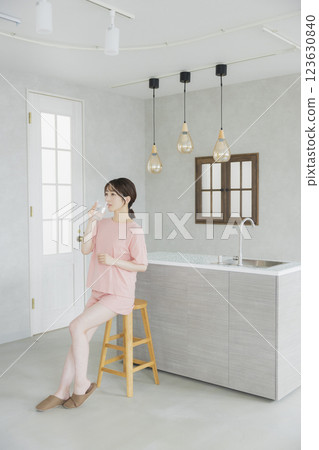 Woman drinking water in the kitchen 123630840