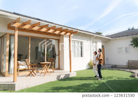 A couple standing in the garden of their beautiful home 123631580