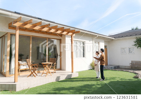 A couple standing in the garden of their beautiful home 123631581
