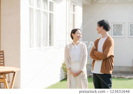 Couple looking up at their lovely house 123631646