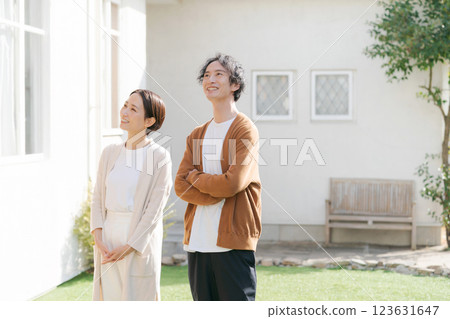 Couple looking up at their lovely house 123631647