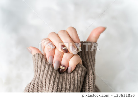 Nail salon - woman doing gel nails (beige, brown, autumn/winter design) Nail salon - woman doing gel nails (beige, brown, autumn/winter design) 123631856