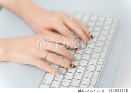 Woman with nails using a computer (work, gel nails, fashion designer) 123631858