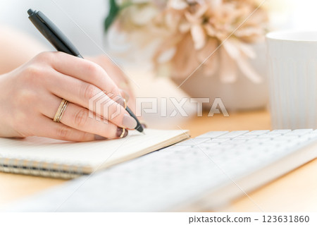 A woman taking notes or writing something (study, work, author, writer, diary, notebook, nails) 123631860