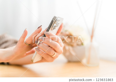 A woman with nails touching a smartphone screen A woman with nails touching a smartphone screen 123631863