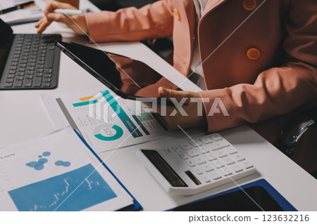 Cropped image of professional businesswoman working at her office via laptop, young female manager using portable computer device while sitting at modern loft, flare light, work process concept Cropped image of professional businesswoman working at her office via laptop, young female manager using portable computer device while sitting at modern loft, flare light, work process concept 123632216