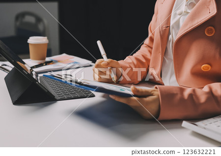 Cropped image of professional businesswoman working at her office via laptop, young female manager using portable computer device while sitting at modern loft, flare light, work process concept Cropped image of professional businesswoman working at her office via laptop, young female manager using portable computer device while sitting at modern loft, flare light, work process concept 123632221