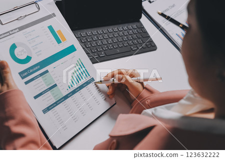 Cropped image of professional businesswoman working at her office via laptop, young female manager using portable computer device while sitting at modern loft, flare light, work process concept 123632222
