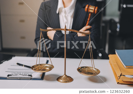 Judge gavel with Justice lawyers having team meeting at law firm background. Concepts of Law and Legal services. 123632260