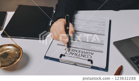 Judge gavel with Justice lawyers having team meeting at law firm background. Concepts of Law and Legal services. 123632288