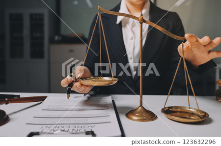 Judge gavel with Justice lawyers having team meeting at law firm background. Concepts of Law and Legal services. 123632296