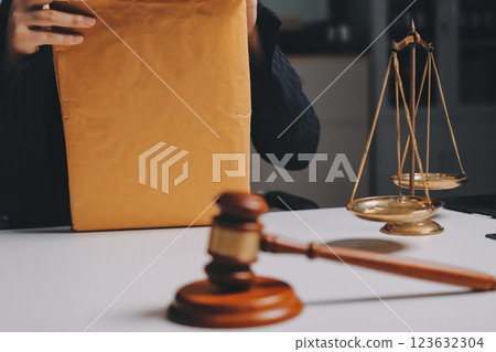 Judge gavel with Justice lawyers having team meeting at law firm background. Concepts of Law and Legal services. 123632304