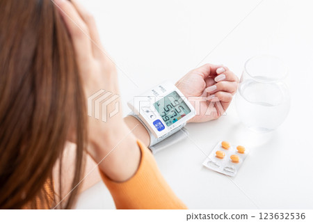 Woman suffering from low blood pressure Woman suffering from low blood pressure 123632536