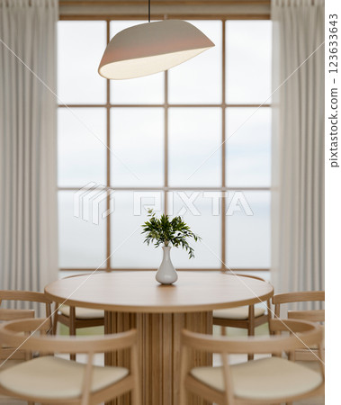 A wooden round table with chair place beside the large wall window. Cosy dining room interiors. 123633643