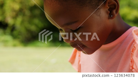 Close up of little girl using a tablet computer in a park Close up of little girl using a tablet computer in a park 123634078