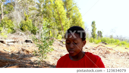 Determined boy climbing a net during obstacle course in boot camp 123634079