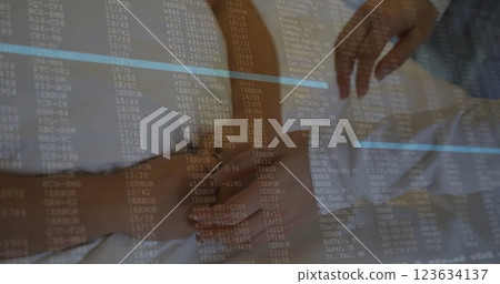 Image of data processing over diverse doctor and patient holding hands in hospital 123634137