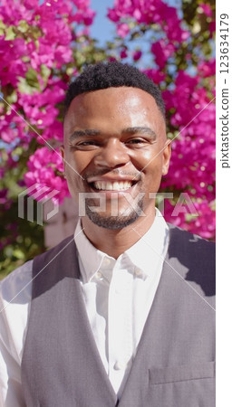 Vertical image of portrait of happy african american man looking at camera and smiling Vertical image of portrait of happy african american man looking at camera and smiling 123634179