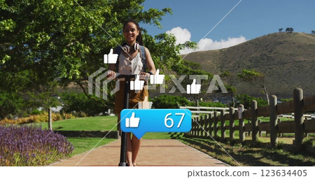 Riding scooter in park, woman over social media likes image 123634405
