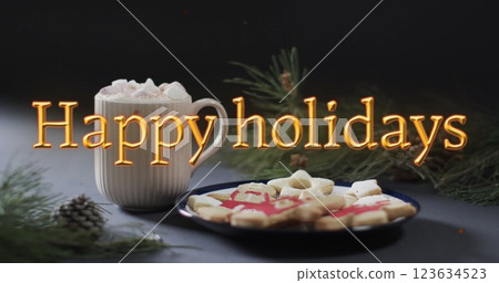 Happy holidays text in orange over christmas hot chocolate and cookies 123634523