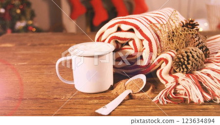 Image of light moving over christmas decoration and mug Image of light moving over christmas decoration and mug 123634894