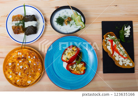 Dishes of traditional Bulgarian cuisine with grape rolls, vegetables and other 123635166