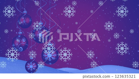 Image of snow falling over christmas baubles decoration and winter scenery 123635321