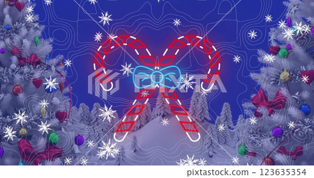Image of snow falling and candy canes over christmas trees and winter landscape 123635354