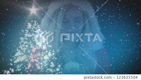 Image of stars over caucasian woman with gift 123635504