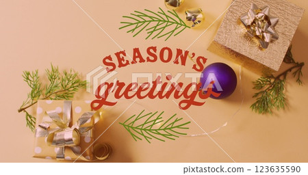 Image of christmas greetings text over christmas presents and decorations 123635590