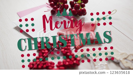 Image of merry christmas text over christmas decorations and envelopes Image of merry christmas text over christmas decorations and envelopes 123635618