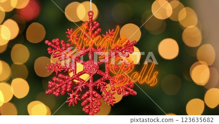 Image of neon jingle bells text banner over hanging snowflake decoration and spots of light Image of neon jingle bells text banner over hanging snowflake decoration and spots of light 123635682