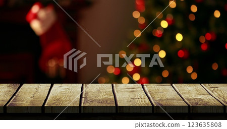 Digital composite of Wooden foreground with Christmas background of tree and stocking Digital composite of Wooden foreground with Christmas background of tree and stocking 123635808