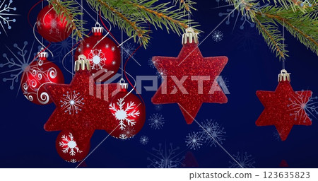 Image of christmas baubles decorations with snow falling 123635823