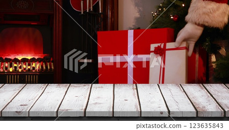 Digital composite of Wooden foreground with Christmas background of Santa with gifts Digital composite of Wooden foreground with Christmas background of Santa with gifts 123635843