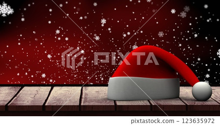 Image of white snowflakes falling over christmas hat and red night sky Image of white snowflakes falling over christmas hat and red night sky 123635972