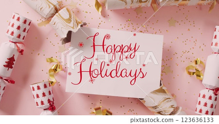Image of christmas greetings text over christmas crackers Image of christmas greetings text over christmas crackers 123636133