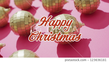 Image of christmas greetings text over christmas gold baubles 123636181